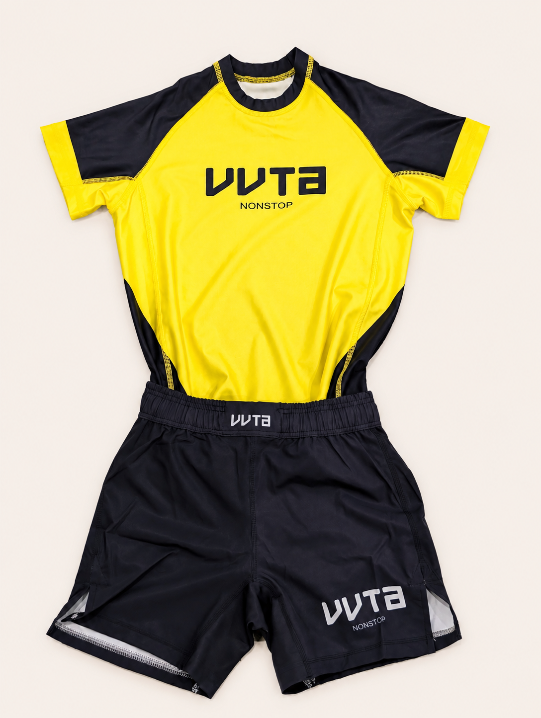 A two-piece athletic set featuring a bright yellow and black short-sleeve jersey with 'VvTA NONSTOP' printed on the chest, paired with matching black shorts that have 'VvTA' on the waistband and leg.