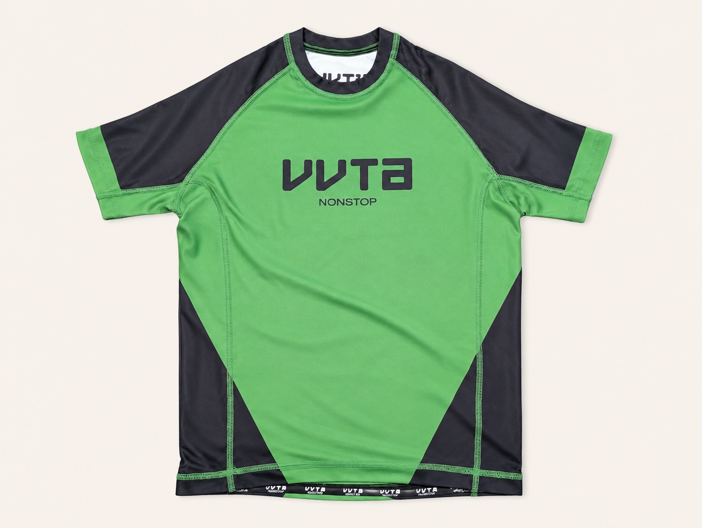 A short-sleeve athletic jersey in bright green and black, featuring the brand name 'VVTA' printed vertically on the chest, laid flat against a light beige background.